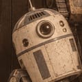R2-D2: a domed white robot with one round eye.